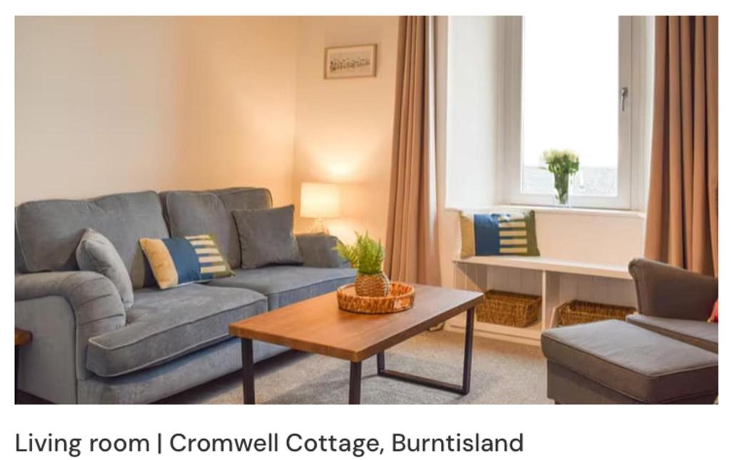 a living room with a couch and a coffee table at Burntisland - Stay4 - SeaSide - Sea Views in Burntisland