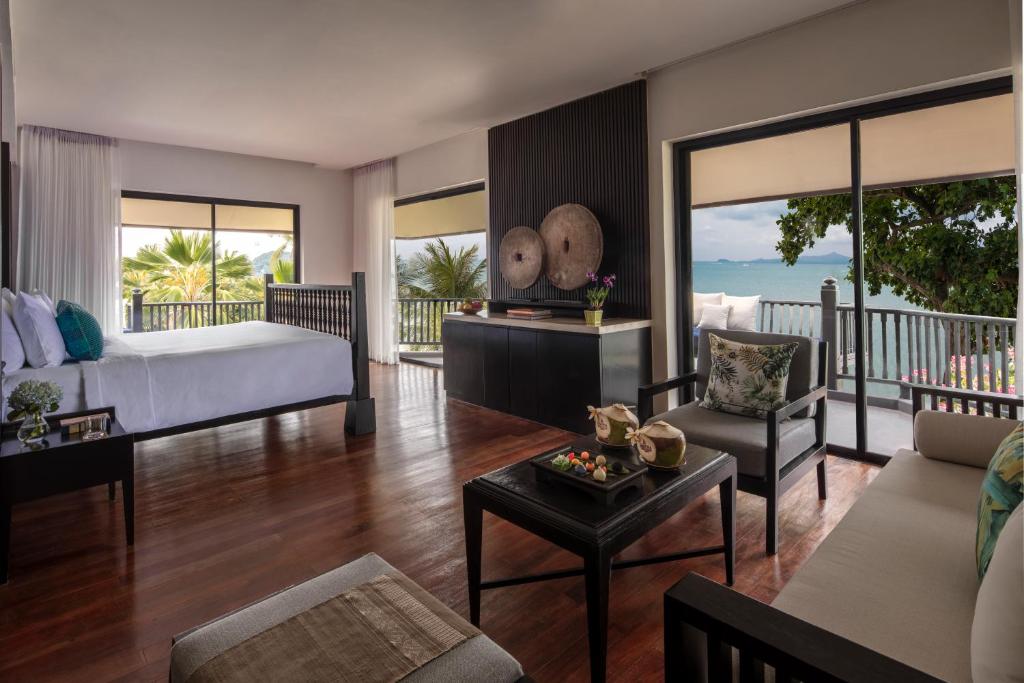 a bedroom with a bed and a living room at Anantara Bophut Koh Samui Resort in Bophut 