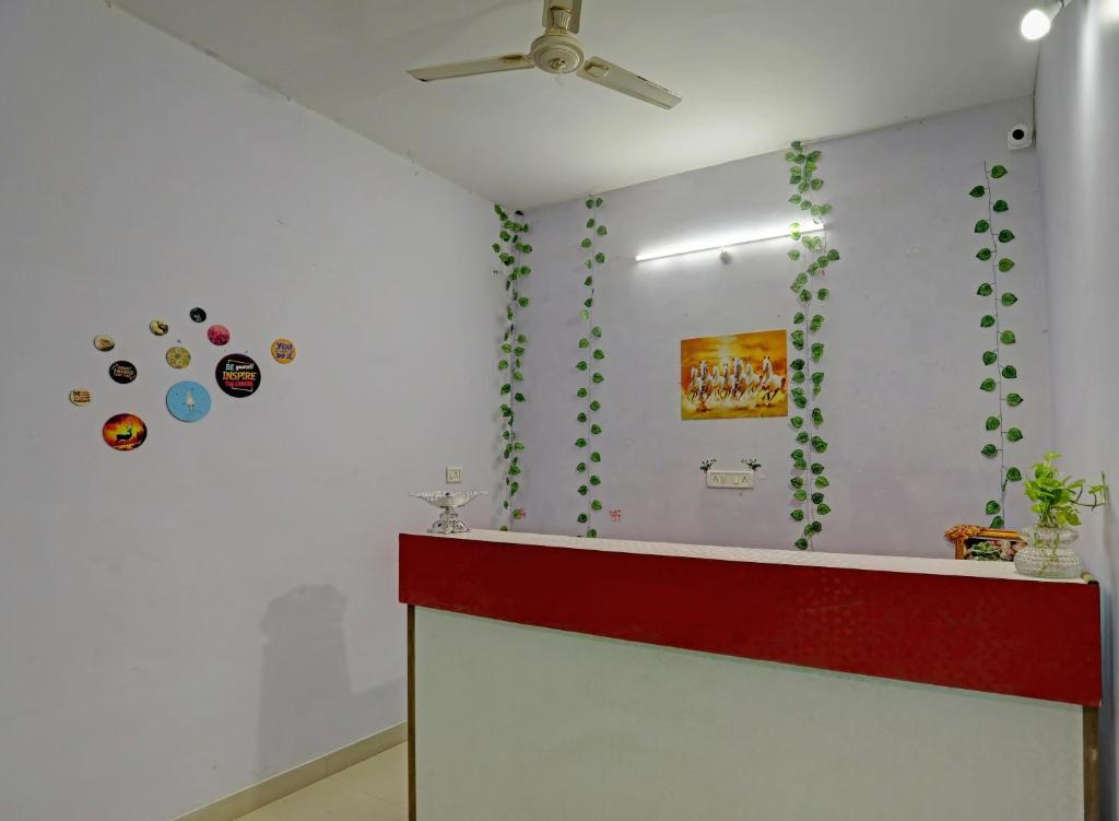 una camera con una parete bianca con piante verdi di Hotel Sambodhi Palace a Bhopal