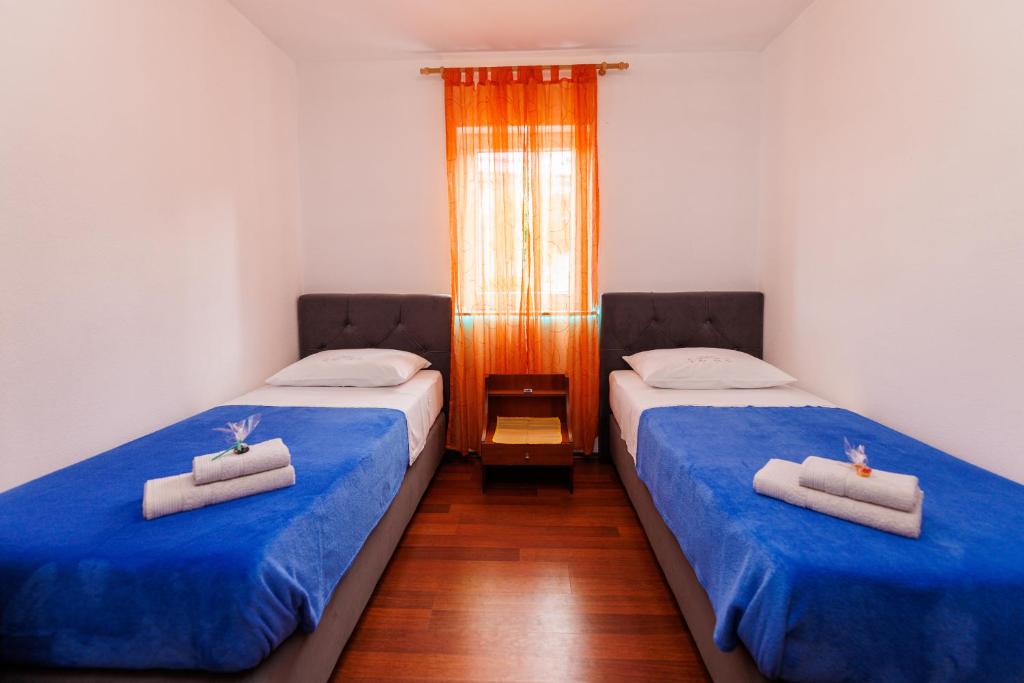 Postel nebo postele na pokoji v ubytování Apartments Stašić Katarina