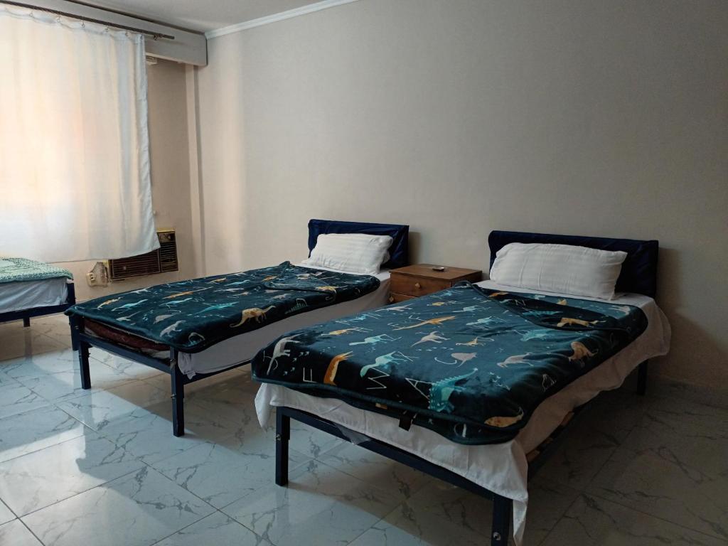 Postel nebo postele na pokoji v ubytování Noor Hotel