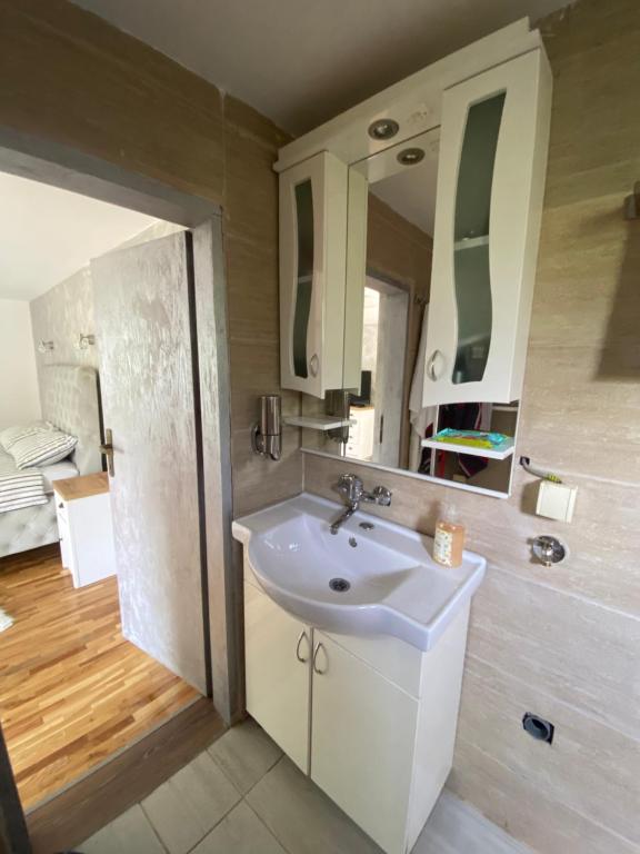 a bathroom with a sink and a mirror at Apartman17 in Belgrade