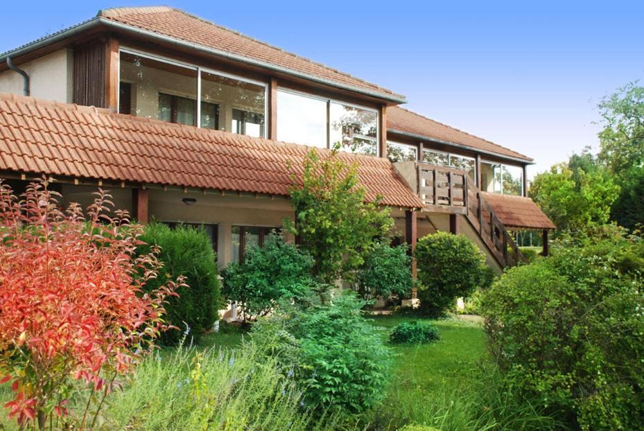 a house with a garden in front of it at The Originals Access, Hôtel La Dousseine, Dreux Nord (Inter-Hotel) in Anet