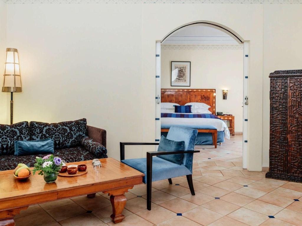 a living room with a couch and a table at Le Médina Essaouira Thalassa Sea & Spa - MGallery Collection in Essaouira
