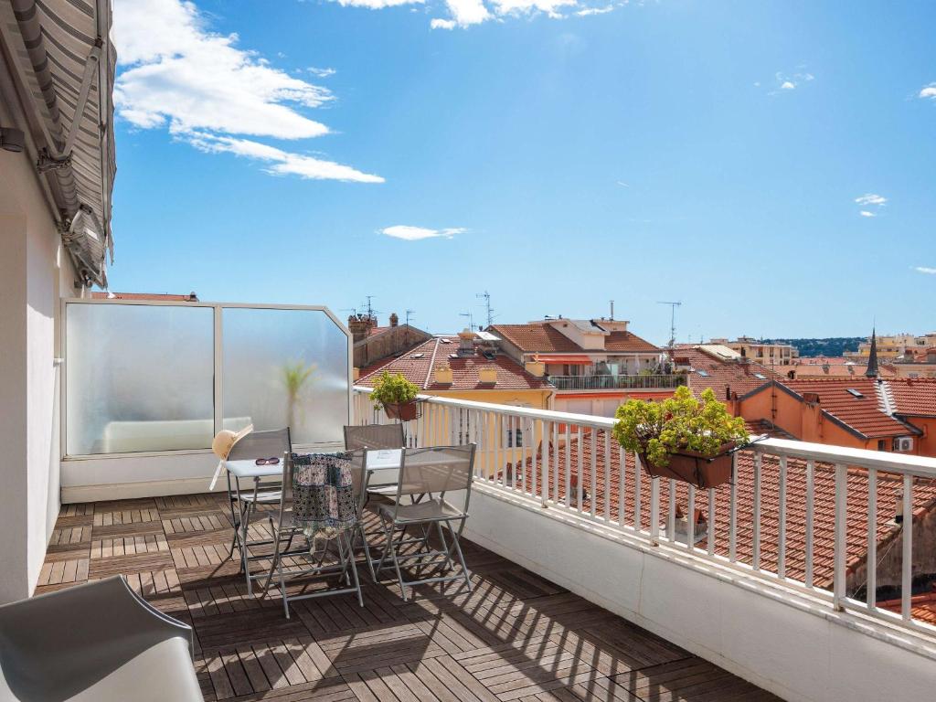 a balcony with a table and chairs on a balcony at Ibis Styles Menton Centre in Menton