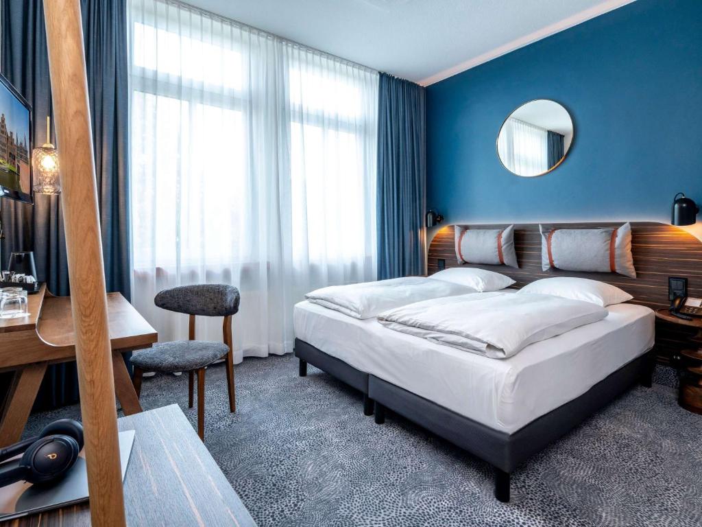 Postel nebo postele na pokoji v ubytování Mercure Hotel Luebeck City Center