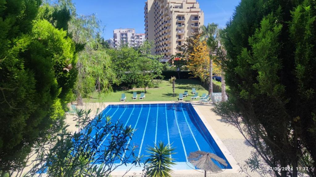 an overhead view of a swimming pool in a city at Casa Jardins da Rocha in Portimão