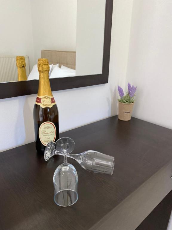 a bottle of champagne and a glass on a counter at La vita e Bella Apartments by Corfuescapes in Kontokali