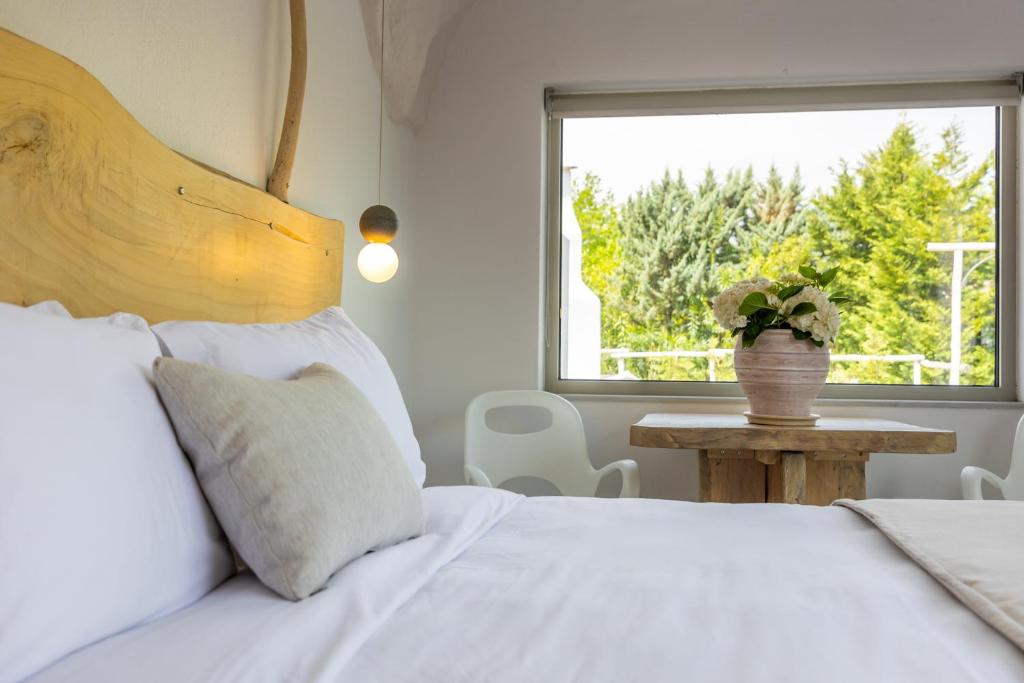 Postel nebo postele na pokoji v ubytování Olympa Suites