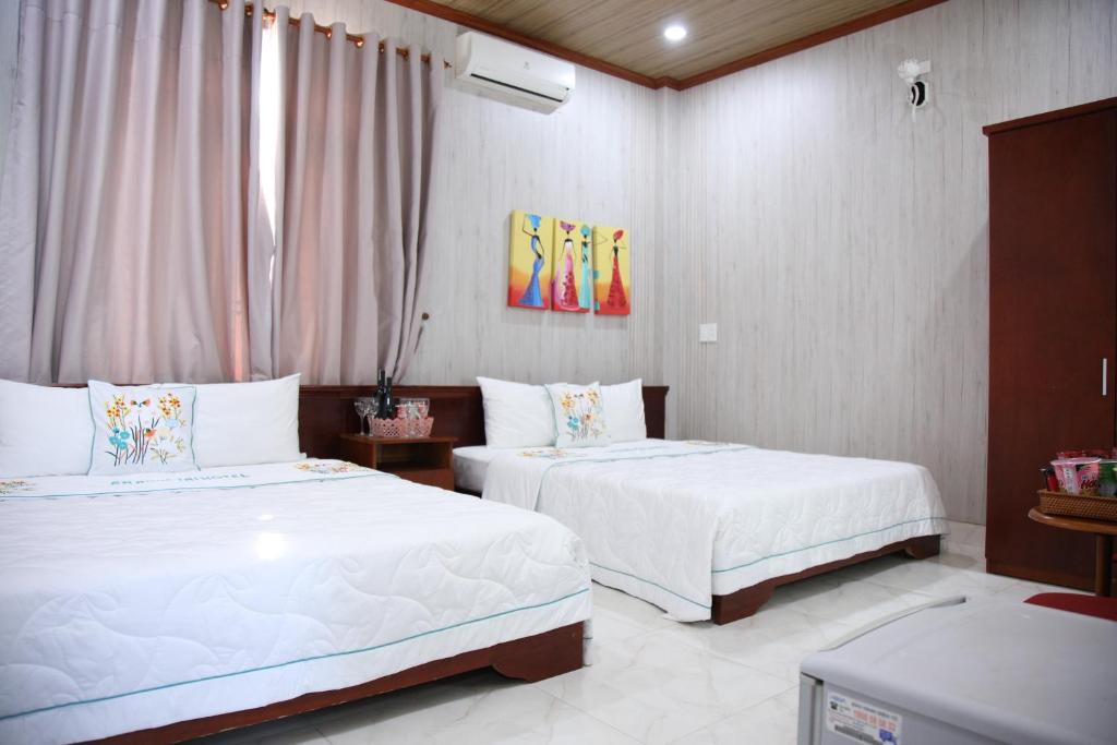 Postel nebo postele na pokoji v ubytování An Bình Tài Hotel