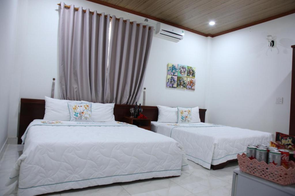 Postel nebo postele na pokoji v ubytování An Bình Tài Hotel