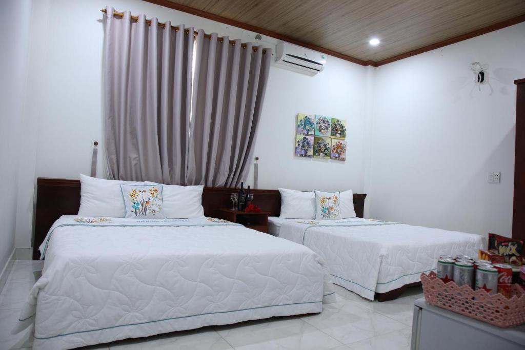 Postel nebo postele na pokoji v ubytování An Bình Tài Hotel