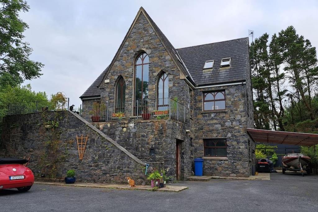 a stone house with a staircase on the side of it at Knockillaree in Galway