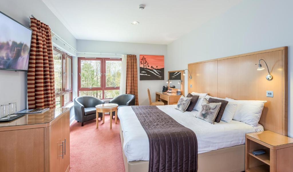 a hotel room with a bed and a desk at High Range Lodge Hotel in Aviemore