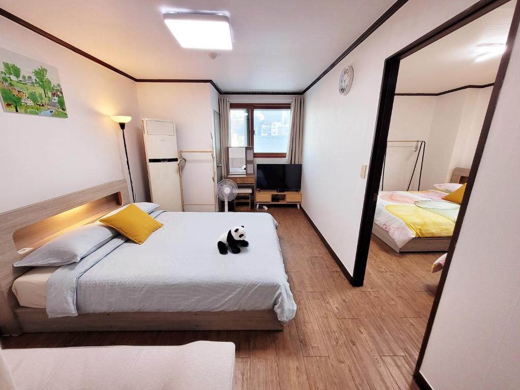a bedroom with a cat sitting on a bed at Travel Apartment in Seoul