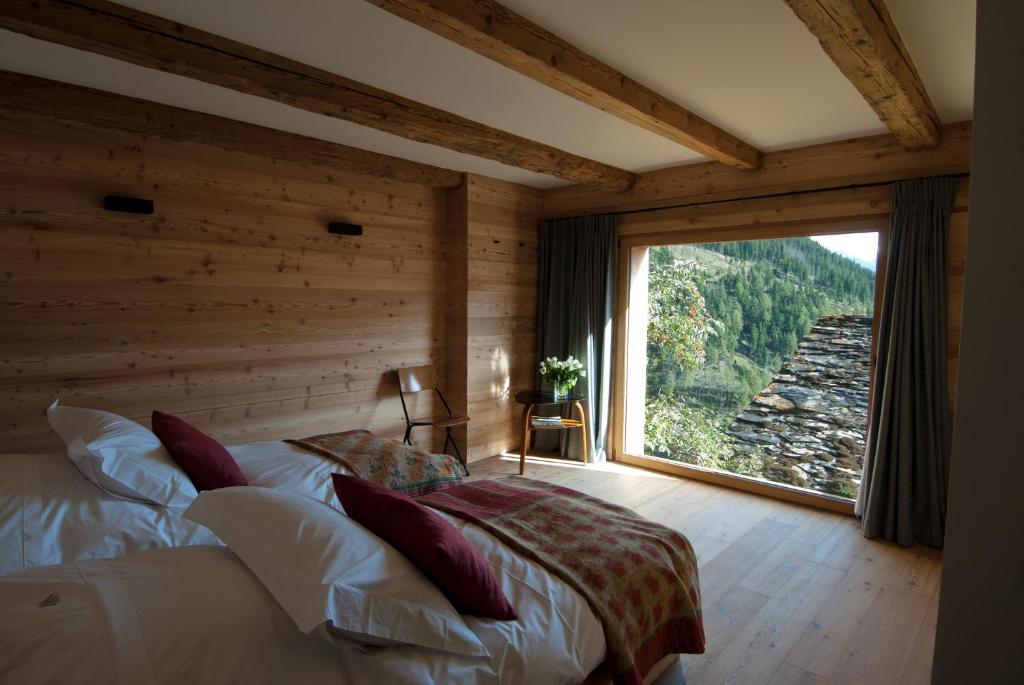 A bed or beds in a room at Montagne Alternative