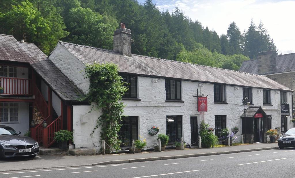 an old white building on the side of a street at Dragon Bed and Breakfast in Betws-y-coed