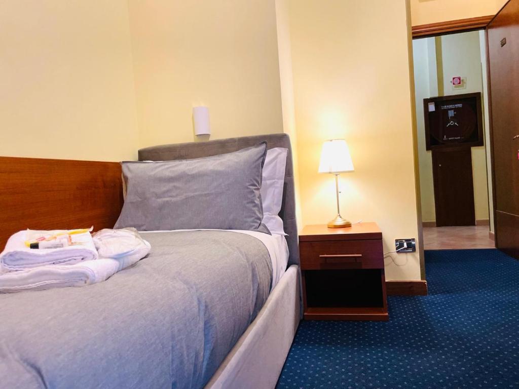 Postel nebo postele na pokoji v ubytování Hotel Rome place