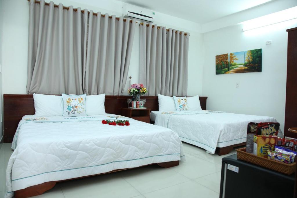 Postel nebo postele na pokoji v ubytování An Bình Tài Hotel