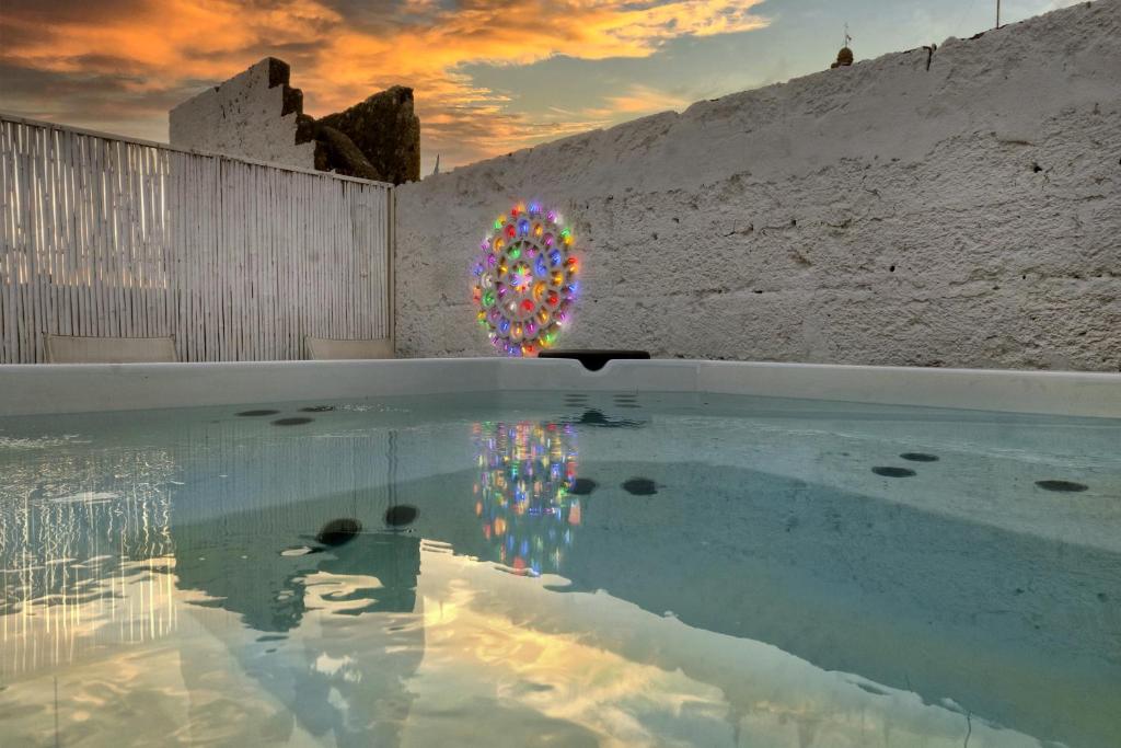 een plas water met een kleurrijke bol in een muur bij Il Nido Luxury Suites in Montesano Salentino