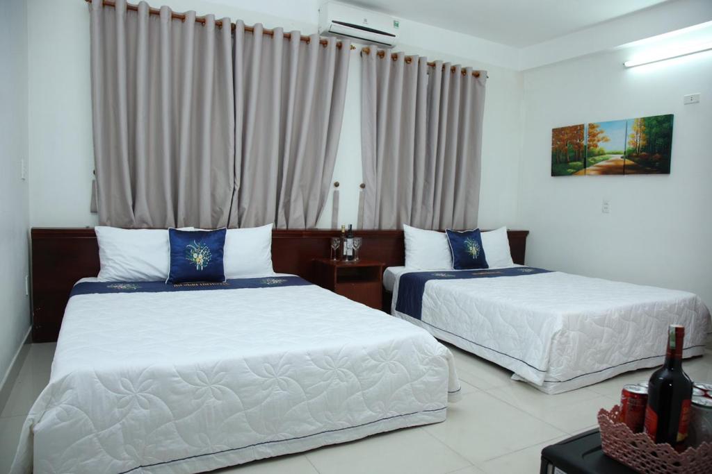 Postel nebo postele na pokoji v ubytování An Bình Tài Hotel