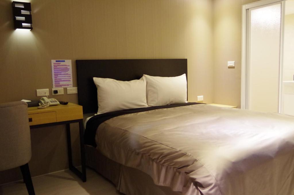 Postel nebo postele na pokoji v ubytování E-House Xining Branch