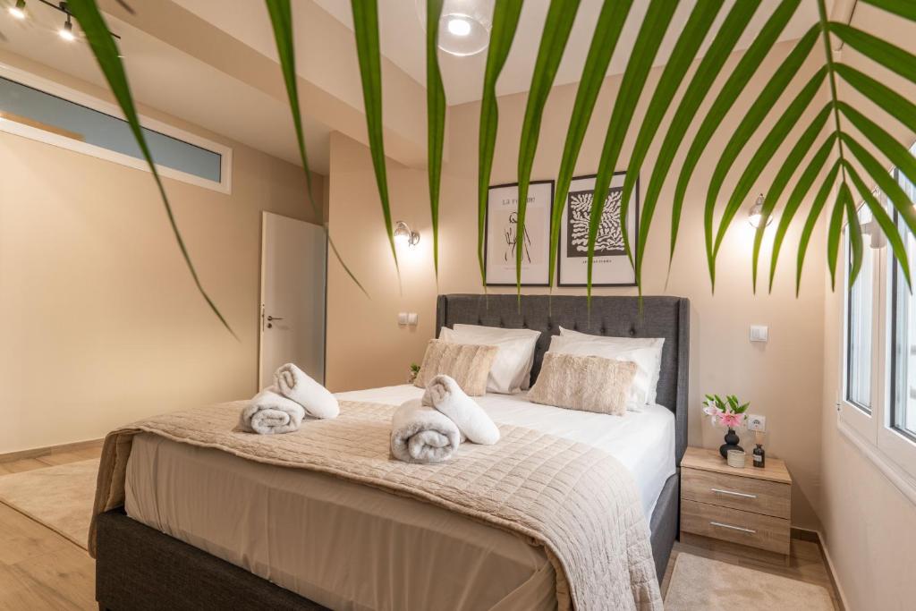 a bedroom with a large bed with towels on it at Lilium Luxury Apartment in Igoumenitsa