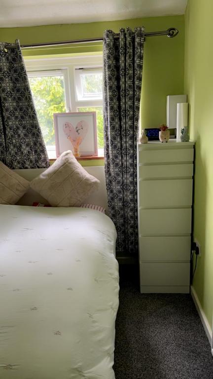 een slaapkamer met een wit bed en een raam bij 6 badger way in Hatfield