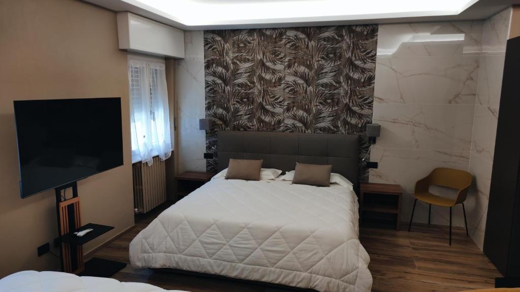 Postel nebo postele na pokoji v ubytování Hotel Emiliana