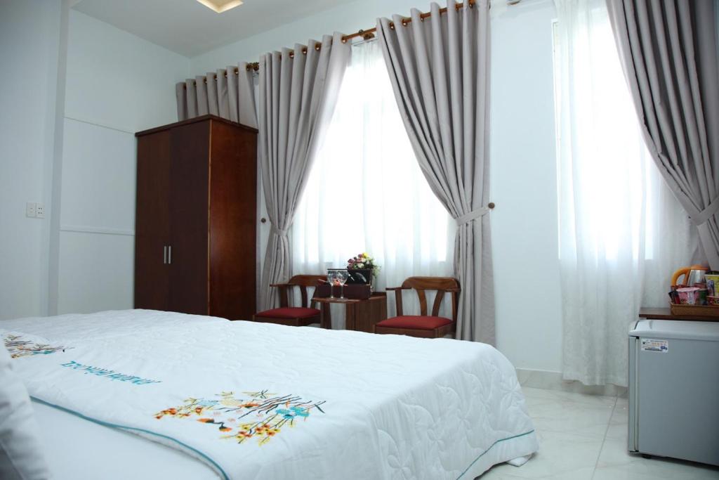 Postel nebo postele na pokoji v ubytování An Bình Tài Hotel