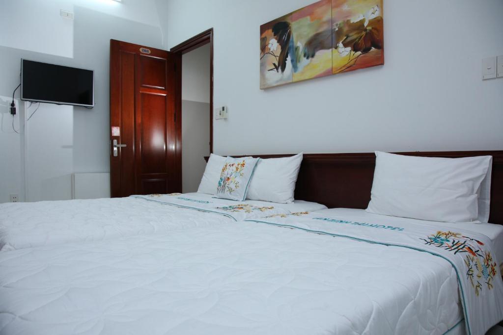 Postel nebo postele na pokoji v ubytování An Bình Tài Hotel