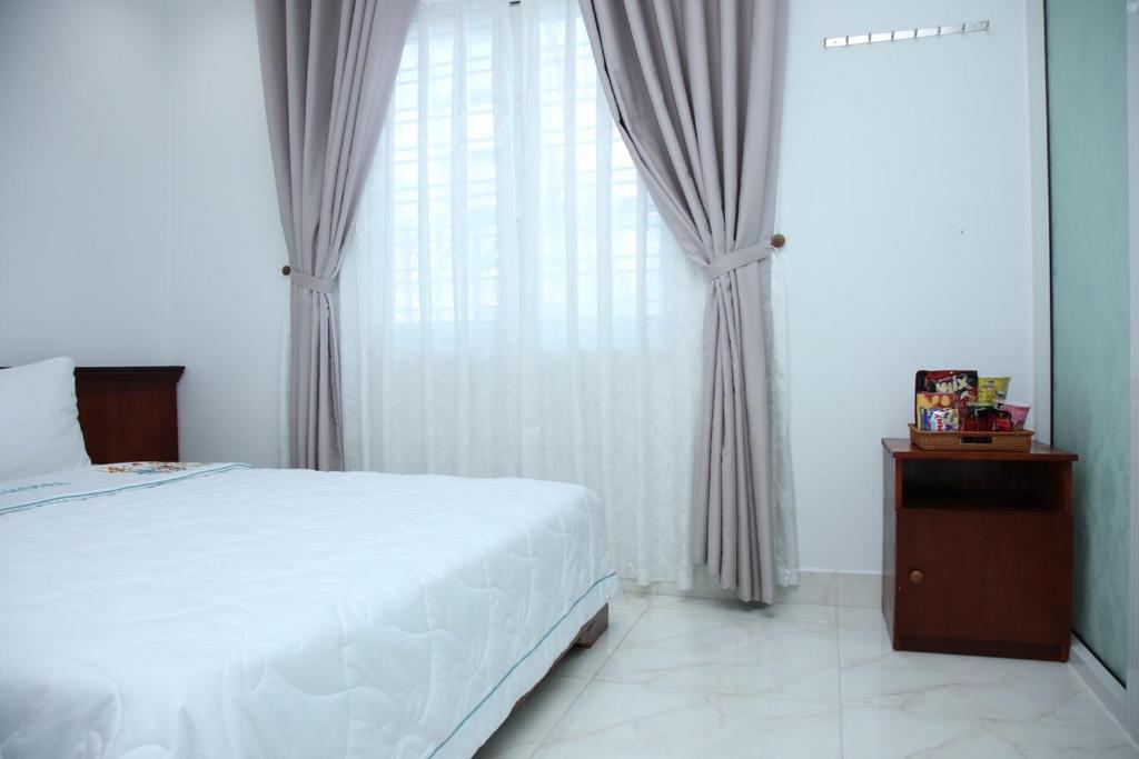Postel nebo postele na pokoji v ubytování An Bình Tài Hotel
