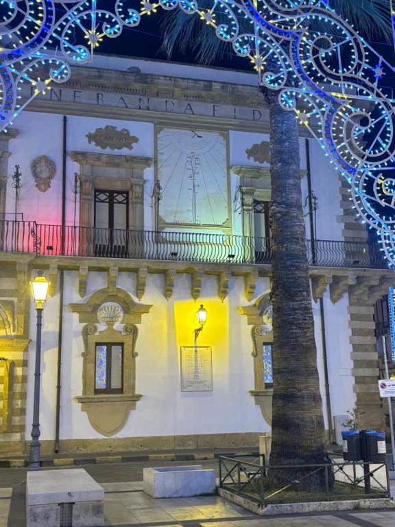 a building with christmas lights on the side of it at La Meridiana in Augusta