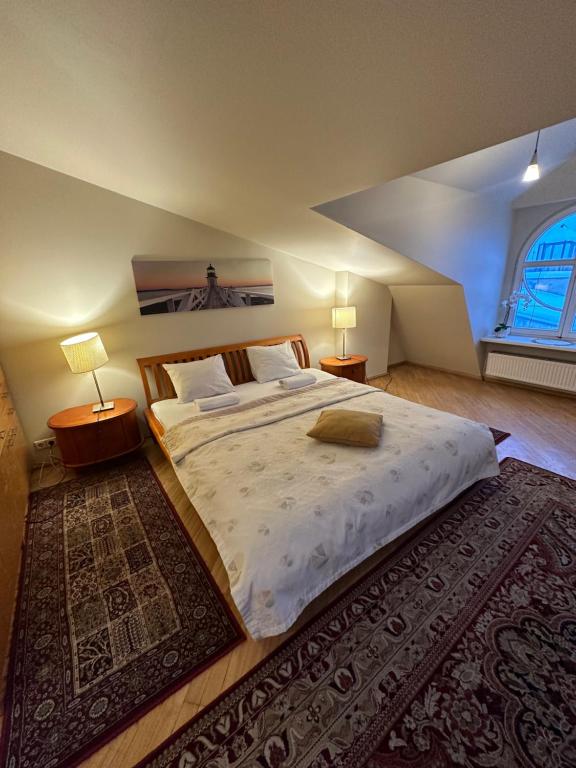 里加Old Town Apartment with Sauna的一间卧室配有一张大床,配有两盏灯和地毯