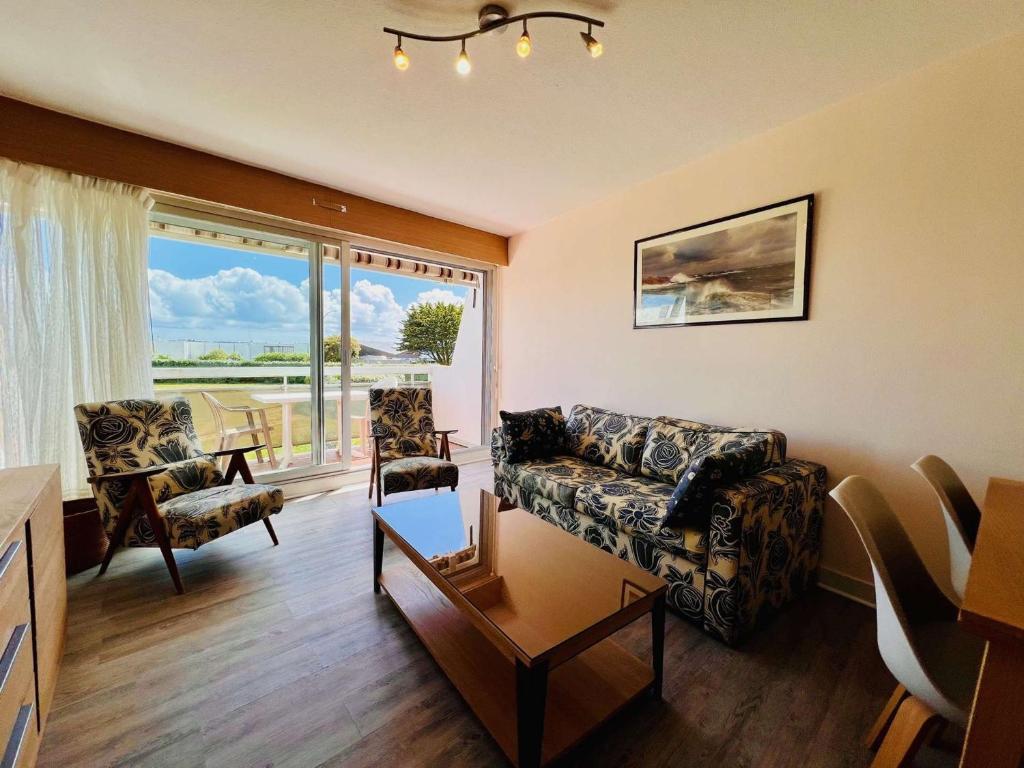 un salon avec un canapé, des chaises et une fenêtre dans l'établissement Quiberon 2P 44m², Wifi, Parking, Animaux acceptés - FR-1-478-90, à Quiberon