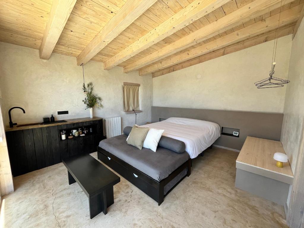 a bedroom with a bed and a couch and a table at Cabañas Agotzenea in Zubiri
