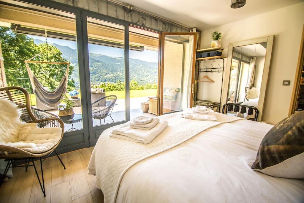 a bedroom with a large bed and a large window at Stylish place-Amazing Views-3 main lifts, Apt design- vue splendide-3 Telecabines in Samoëns
