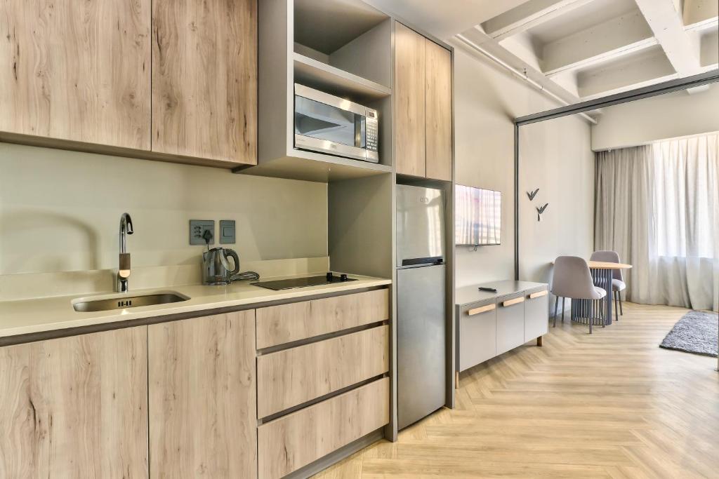 Kuchyň nebo kuchyňský kout v ubytování WINK Aparthotel One Thibault
