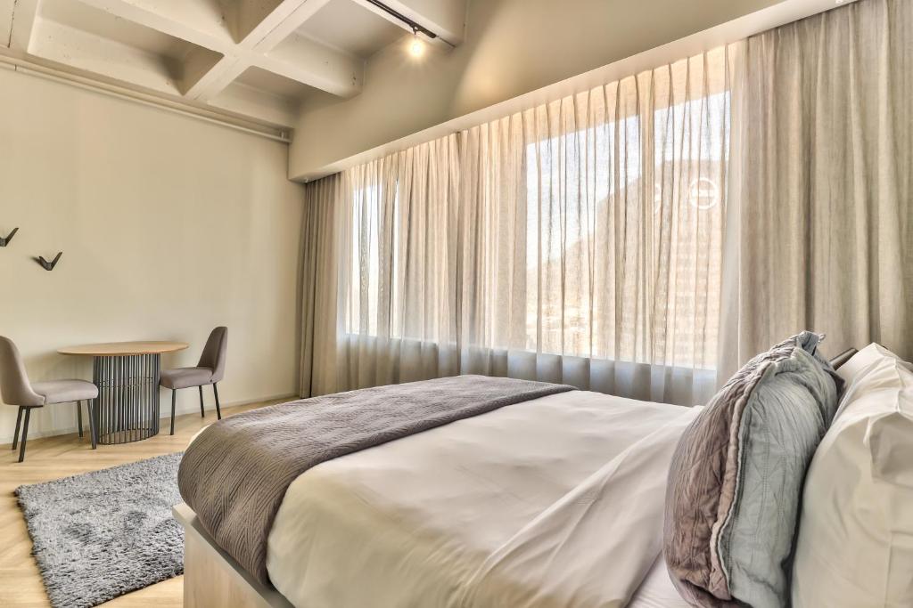 Postel nebo postele na pokoji v ubytování WINK Aparthotel One Thibault