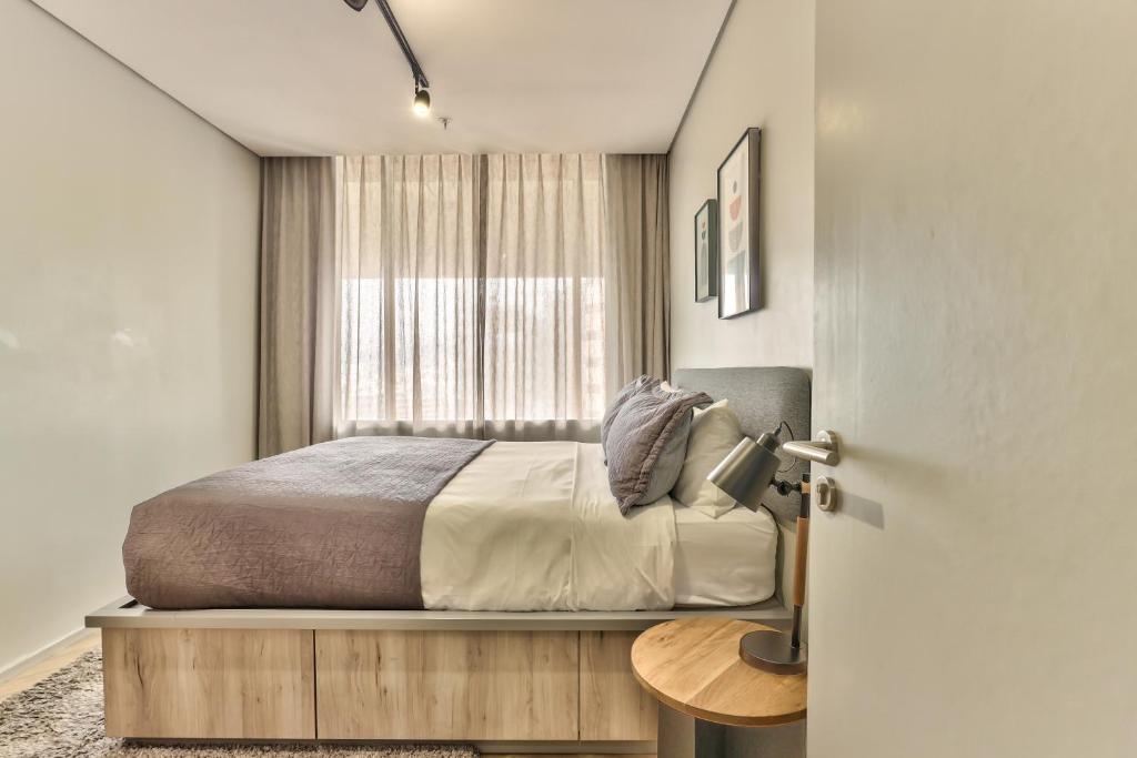 Postel nebo postele na pokoji v ubytování WINK Aparthotel One Thibault