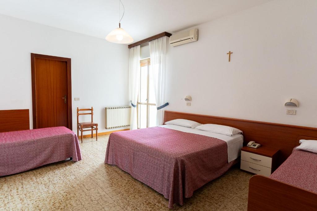 Postel nebo postele na pokoji v ubytování Hotel Lem-Casadei