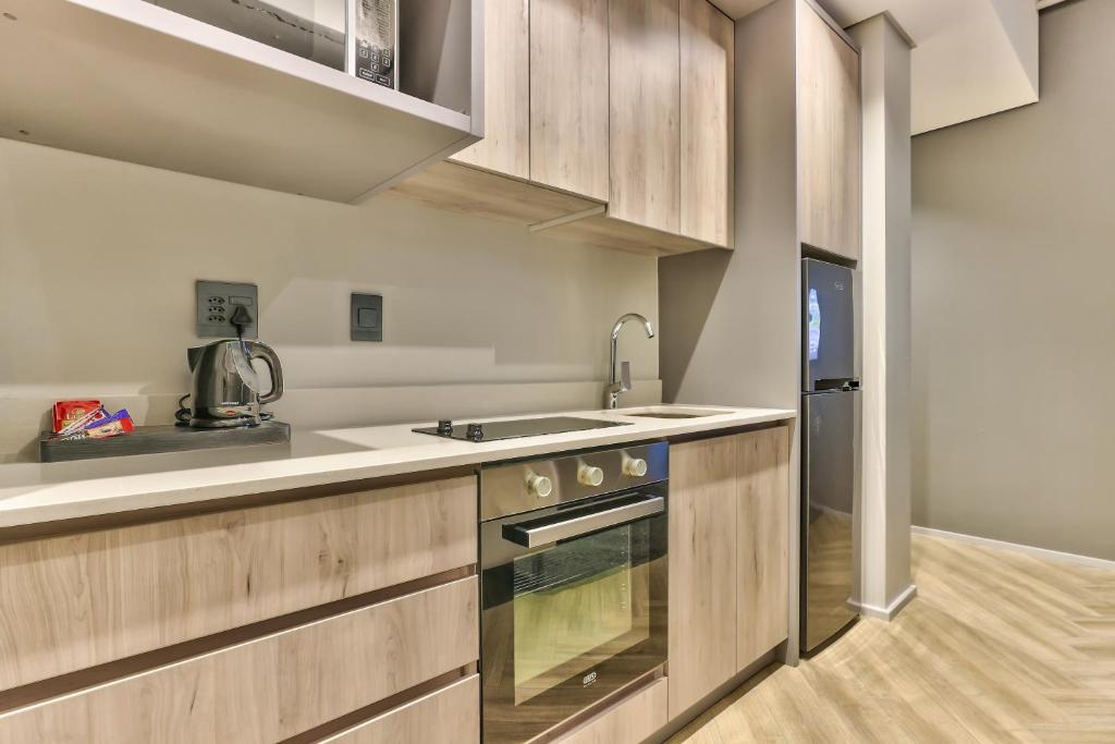 Kuchyň nebo kuchyňský kout v ubytování WINK Aparthotel One Thibault