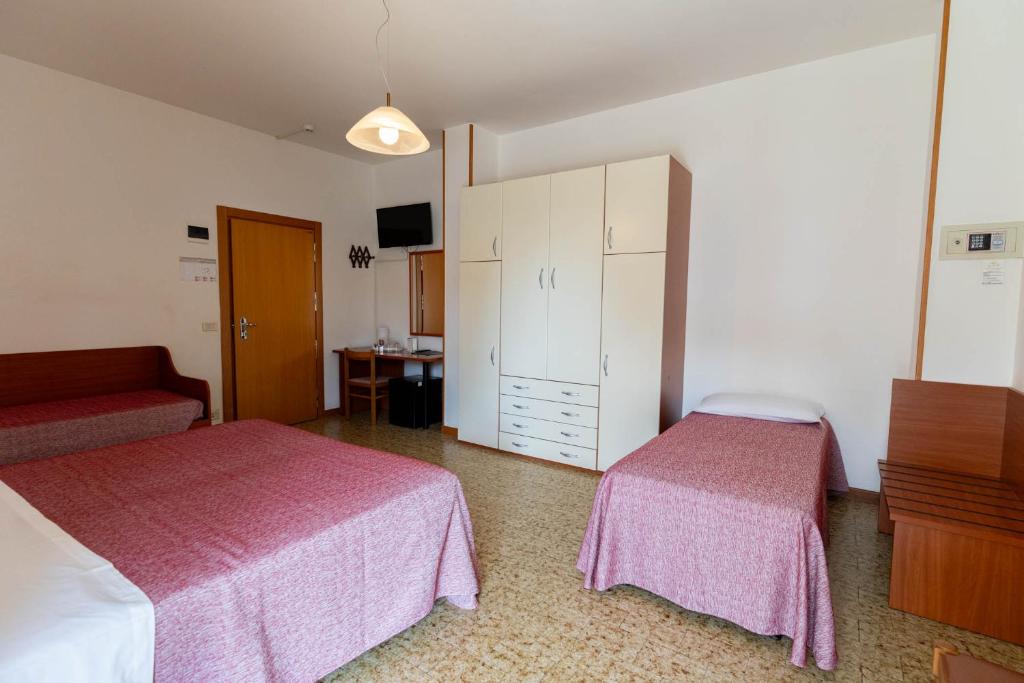 Postel nebo postele na pokoji v ubytování Hotel Lem-Casadei