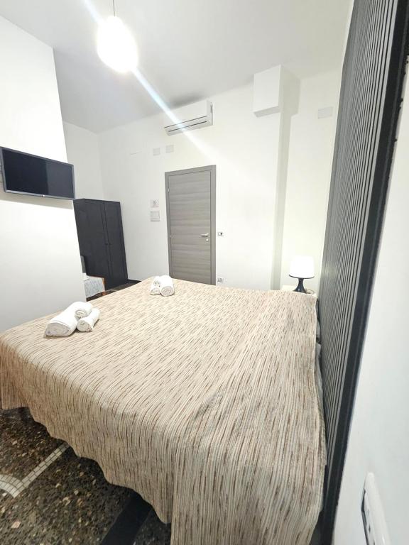 a bedroom with a large bed with towels on it at Affittacamere House LeoMar di Sara in Genoa