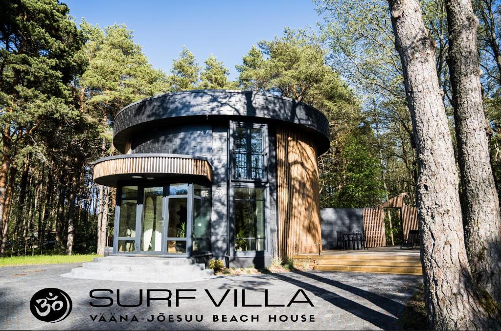 a round house in a park with trees at Surf Villa in Vääna-Jõesuu