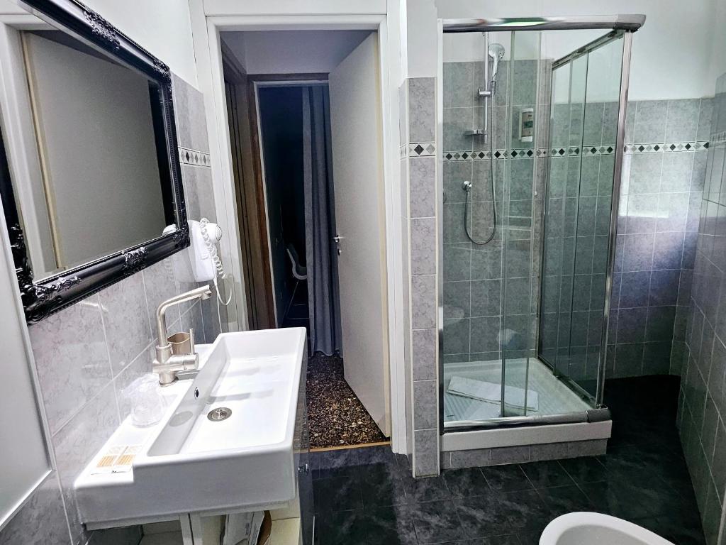 a bathroom with a sink and a shower at Affittacamere House LeoMar di Sara in Genoa