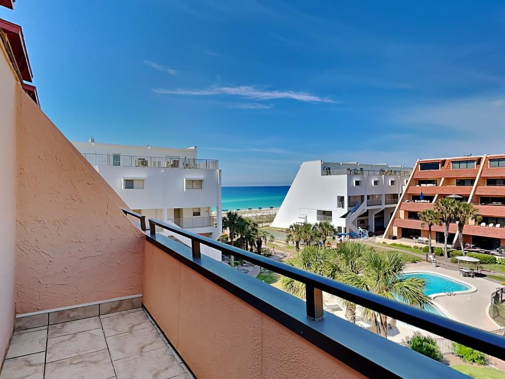 a balcony with a view of the beach and buildings at Aegean 327 in Destin