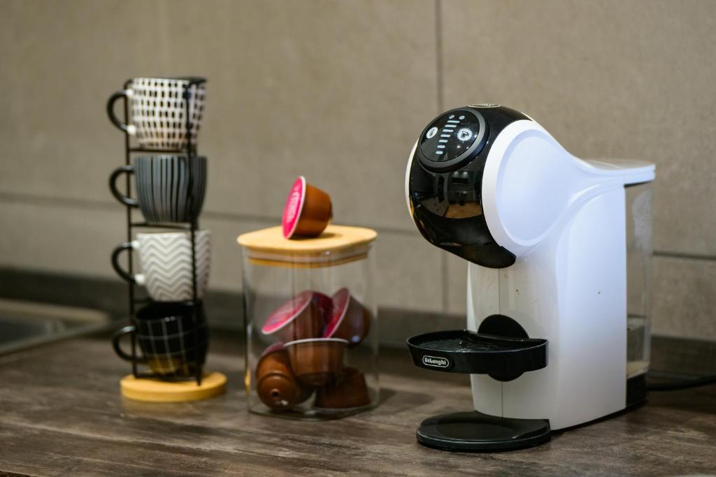 a coffee maker sitting on a counter next to shoes at Loft Sea&Sky Fiumicino Airport in Fiumicino