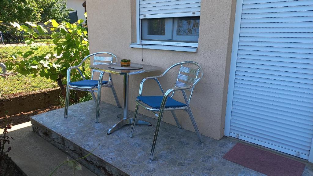two chairs and a table on a patio at Airplane Apartment T&amp;T in Surčin