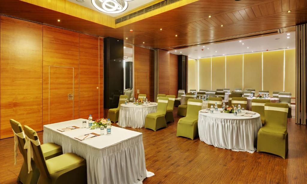 a room with two tables and chairs and a room with tables and chairsktop at Click Hotel Bhuj in Bhuj